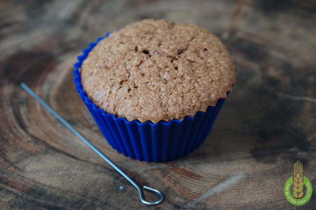 Make the "needle test" to see if the muffins are ready to be taken out of the oven (gluten-free chocolate-walnut muffins).