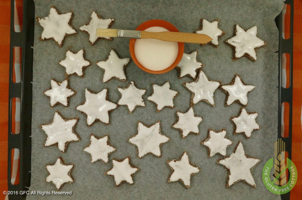 Spread egg white glaze on cookies (gluten-free cinnamon cookies).