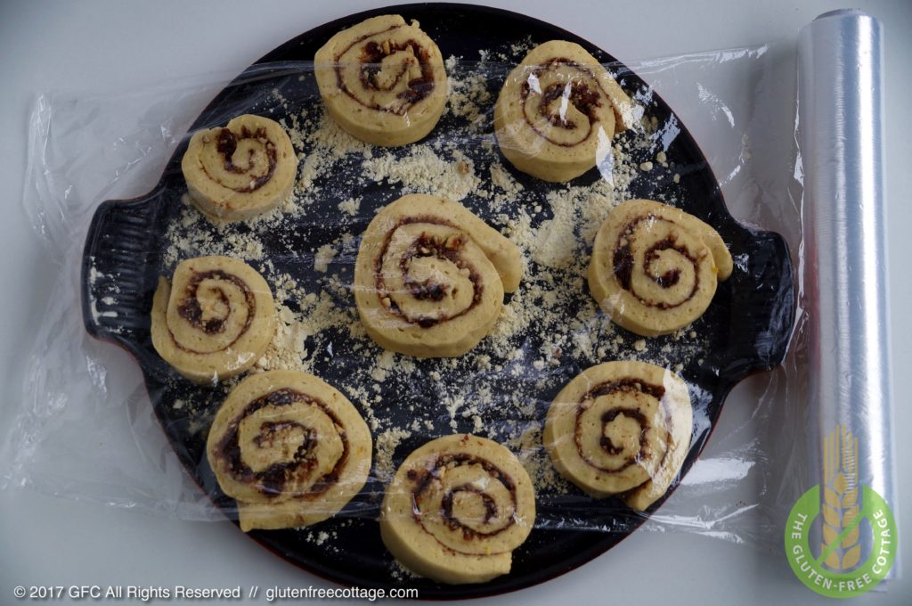 Slice dough roll into pieces and place on floured baking pan (gluten-free cinnamon rolls/ Danish).