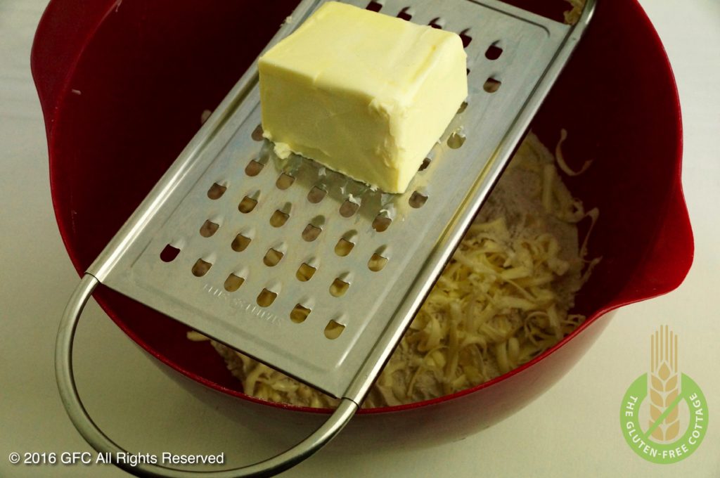 Grating of butter (gluten-free upside down apple pie/ tarte tatin).