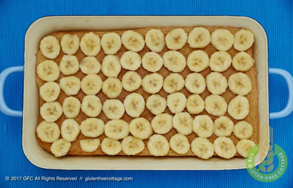 Banana slices spread over cake (gluten-free banana cake with chocolate glaze).