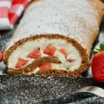 Gluten-free chocolate roll cake with strawberries.
